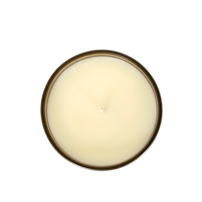 A top-down view of a soy candle is shown. The wax is a natural beige color, with a white cotton wick in the middle.